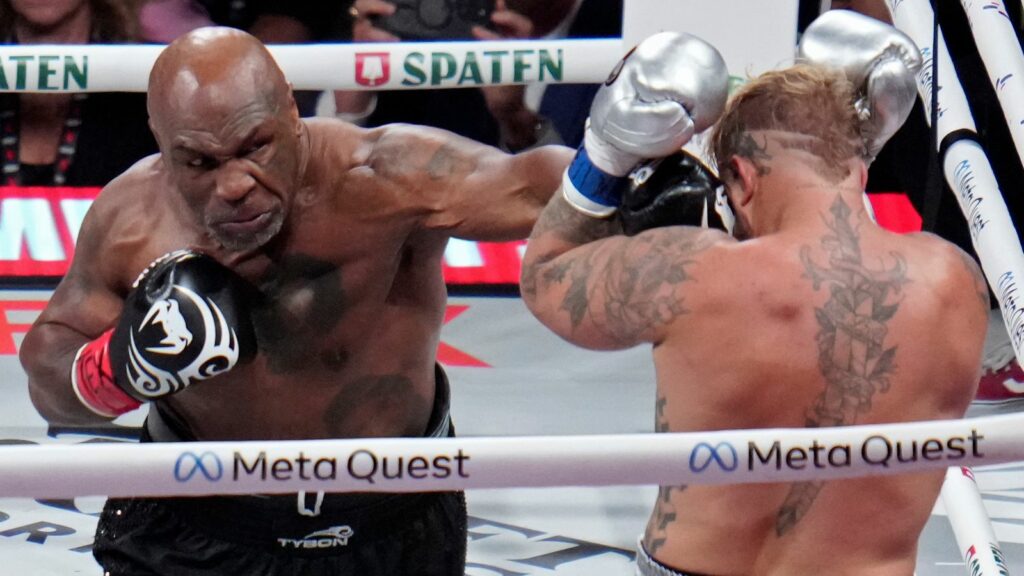 Mike Tyson lands a left to Jake Paul during their heavyweight boxing match, Friday, Nov. 15, 2024, in Arlington, Texas. (AP Photo/Julio Cortez)