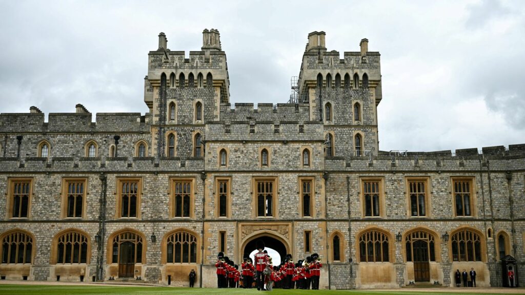 The Band of the Irish Guards, led by the Irish Guards' Regimental Mascot, an Irish wolfhound named Seamus (Turlough Mor), march into Windsor Castle's Quadrangle through the George IV Gate during a ceremony where Britain's King Charles III presents New Colours to No 9 and No 12 Company The Irish Guards at Windsor Castle, west of London, on June 10, 2024. The new Colours will be those trooped in the Trooping of the Colour at His Majesty's official Birthday Parade in London on Saturday June 15, 202