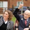 Handout photo of Second World War veteran Captain Tom Moore with his daughter Hannah, as they wave to a Battle of Britain Memorial Flight flypast of a Spitfire and a Hurricane passing over his home as he celebrates his 100th birthday.