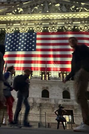 People pass the New York Stock Exchange in New York's Financial District on Tuesday, Nov. 5, 2024. (AP Photo/Peter Morgan)