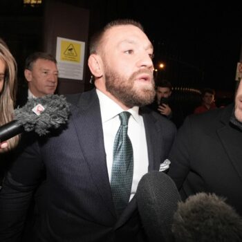 Mixed martial arts fighter Conor McGregor (centre) and partner Dee Devlin leave the High Court in Dublin after the personal injury case against him. Nikita Hand, who is also known as Nikita Ni Laimhin, alleges she was raped by McGregor in a Dublin hotel in December 2018. After deliberating for six hours and 10 minutes, the jury returned with their verdicts in the civil trial against Conor McGregor. The total amount of damages awarded to Nikita Hand by the jury was 248,603.60 euro. Picture date: Friday November 22, 2024. PA Photo. See PA story IRISH McGregor. Photo credit should read: Brian Lawless/PA Wire