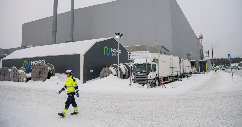 Workers walk at the site of the Northvolt Ett factory in Skelleftea, north Sweden on February 23, 2022. Located in Skelleftea, around 200km from the artic circle in Sweden, the Northvolt 1 Gigafactory is meant to produce electric batteries for 600 000 vehicles a year. The site is already partially operating, although it is still under construction. (Photo by Jonathan NACKSTRAND / AFP)