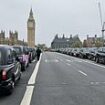 Black cabs line the streets of London to take veterans to and from Remembrance Sunday events for FREE