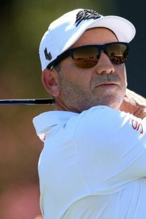 Sergio Garcia in sunglasses with a golf club after taking a shot