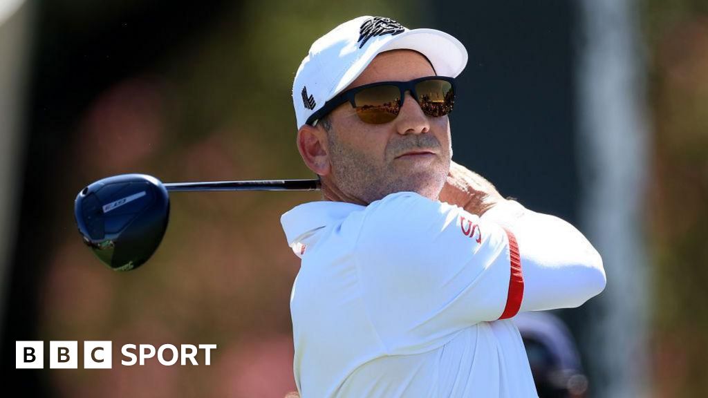 Sergio Garcia in sunglasses with a golf club after taking a shot