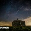 Church building in foreground with a shooting start streaking across the night sky beyond.