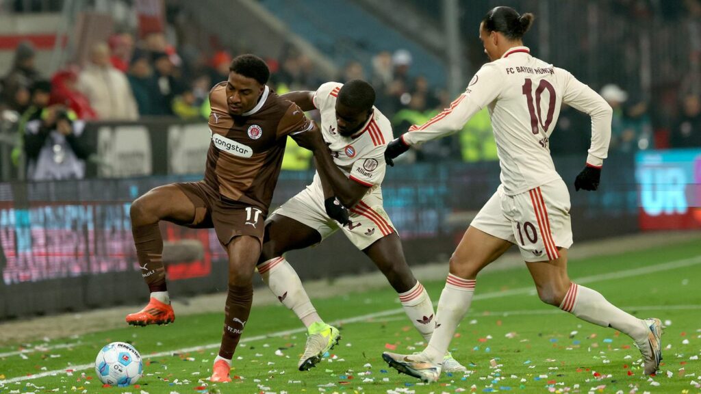 Dayot Upamecano und Leroy Sané (r) vom FC Bayern München gegen Oladapo Afolayan vom FC. St. Pauli