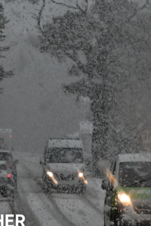 Vehicles navigate snowy conditions near Glenmore on the road to the Cairngorm ski area