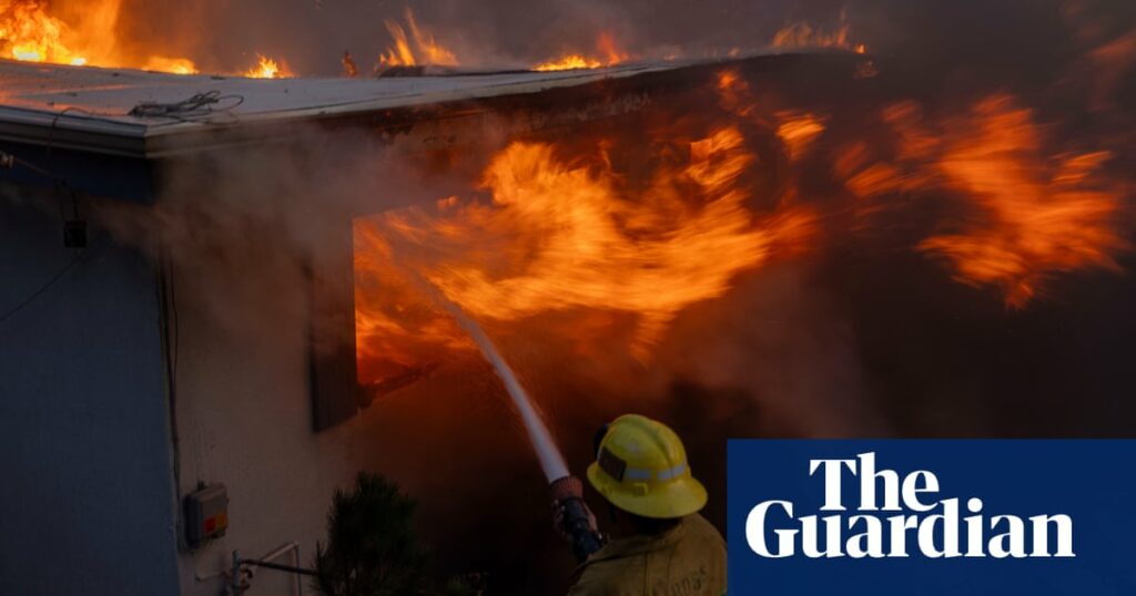 Wind-driven wildfire rages in California with scores of homes charred