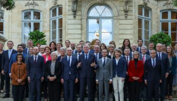 Le Premier ministre Michel Barnier (au centre, mains levées) entouré des membres de son gouvernement à l'issue d'un séminaire à Matignon, à Paris, le 27 septembre 2024