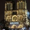 The word 'merci' was projected onto the front of the cathedral. Pic: AP