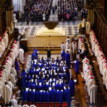 Clergy members and singers of the choir of the Maitrise de Notre-Dame sit in the nave during an inaugural Mass, with the consecration of the high altar, at the Notre-Dame de Paris Cathedral, five-and-a-half years after a fire ravaged the Gothic masterpiece, as part of ceremonies to mark the Cathedral's reopening after its restoration, in Paris, France, Sunday, Dec. 8, 2024. (Sarah Meyssonnier/Pool Photo via AP)