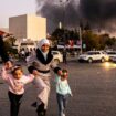 Smoke billows as people arrive to celebrate the fall of the Syrian government, in Damascus, Syria, Sunday, Dec. 8, 2024. (Ugur Yildirim/Dia Photo via AP)