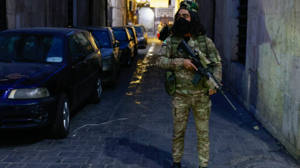 A rebel fighter stands guard in Damascus old city. Pic: Reuters/Ammar Awad