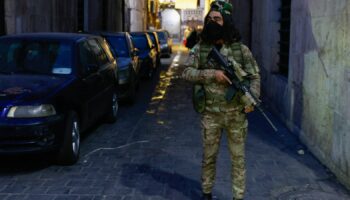 A rebel fighter stands guard in Damascus old city. Pic: Reuters/Ammar Awad