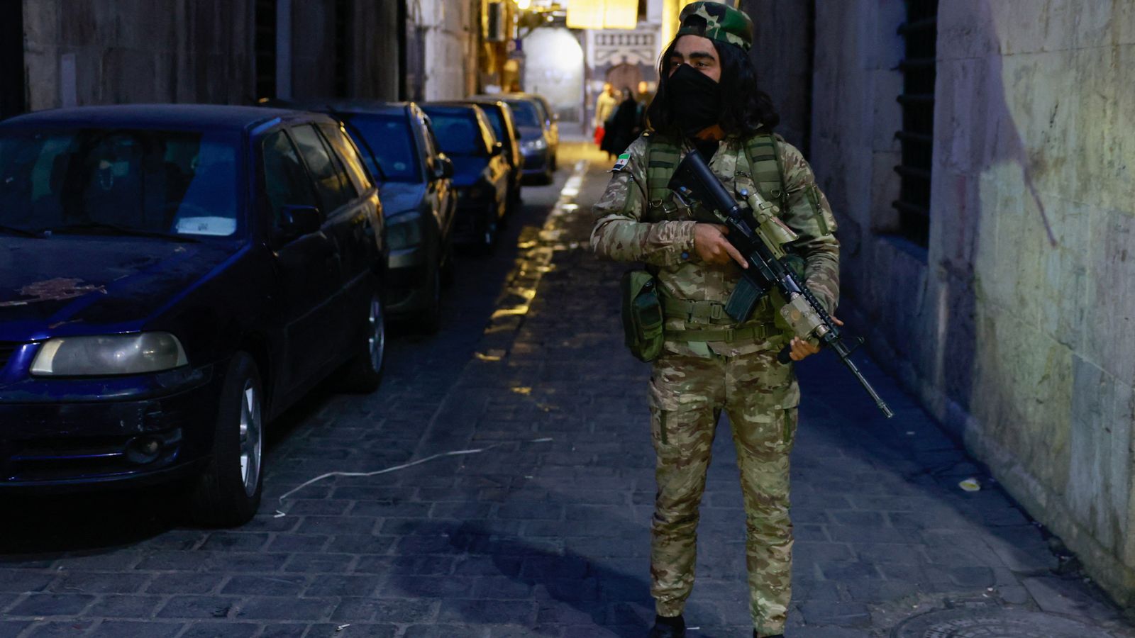 A rebel fighter stands guard in Damascus old city. Pic: Reuters/Ammar Awad