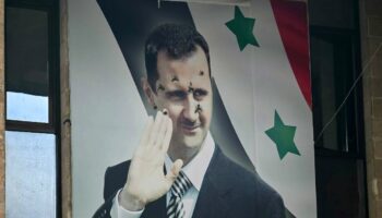 Un poster du président syrien déchu Bachar al-Assad criblé de balles, le 12 dcéembre 2024 à Alep, dans le nord de la Syrie