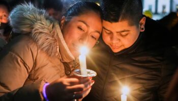 Supporters hold candles during a candlelight vigil Tuesday, Dec. 17, 2024, outside the Wisconsin Capitol in Madison, Wis., following a shooting at the Abundant Life Christian School on Monday, Dec. 16. (AP Photo/Morry Gash)