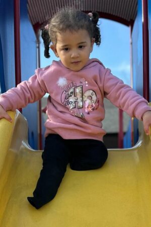 Rafah plays in the park near her new home in Missouri