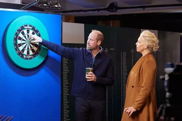 Cider-swigging Prince William channels his inner Luke Littler playing darts with Hannah Waddingham