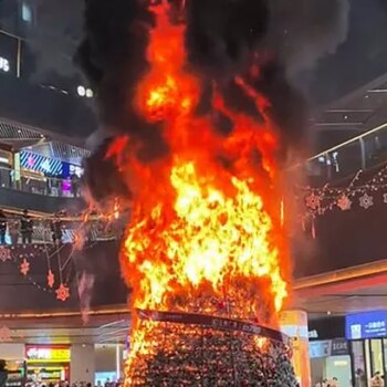 Shocking moment 30ft Christmas tree erupts into flames after crucial error