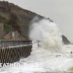 A waves crashing over a sea defence promenade during a storm