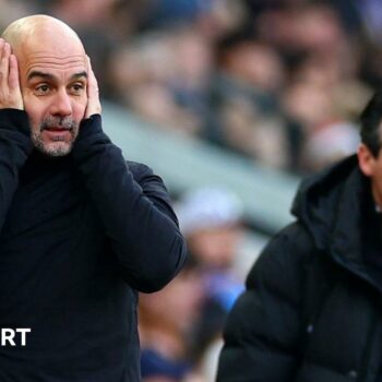 Pep Guardiola holds his hands to his head in despair he as watches his Manchester City side lose at Aston Villa