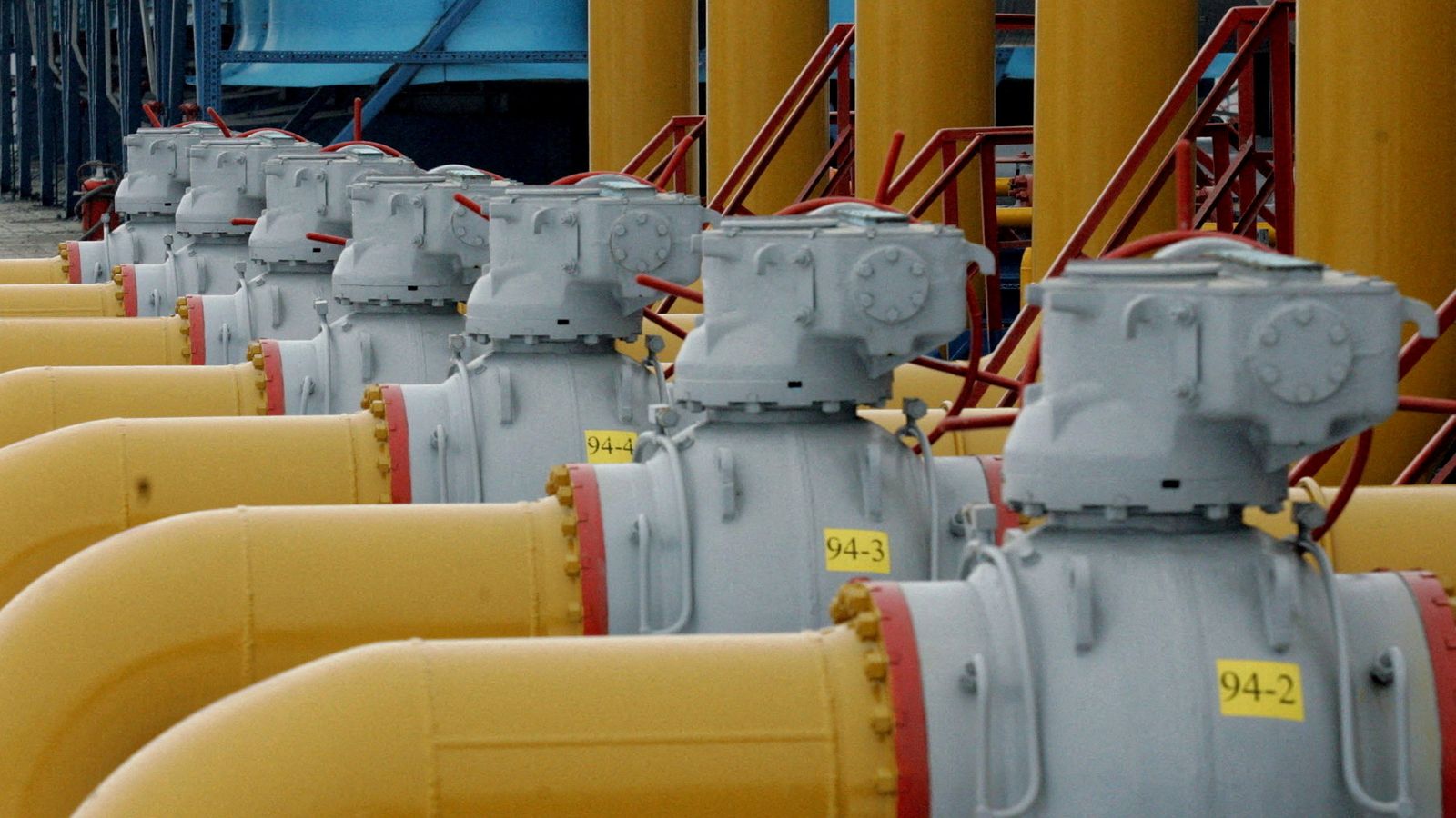 FILE PHOTO: A gas worker walks between pipes in a compressor and distribution station of the Urengoy-Pomary-Uzhgorod gas pipeline, some 30 km (19 miles) from the south western Russian city of Kursk January 4, 2006. REUTERS/Sergei Karpukhin//File Photo