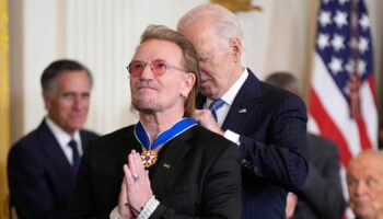 President Joe Biden presents Bono with the Presidential Medal of Freedom. Pic: AP