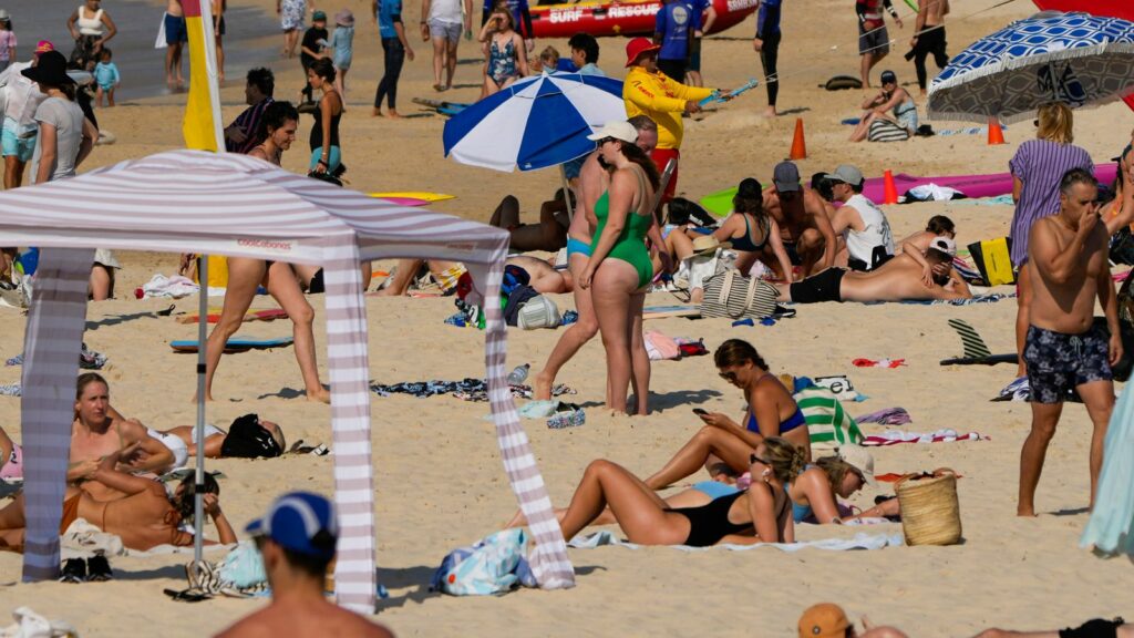 People sunbathe near a cabana at Bondi beach in Sydney. Pic: AP