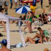 People sunbathe near a cabana at Bondi beach in Sydney. Pic: AP