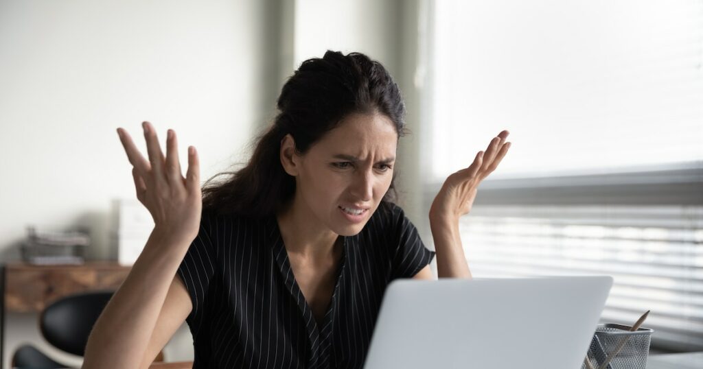 What is wrong. Anxious angry hispanic female splash hands unable to access database on laptop forgetting password having weak wifi signal. Mad shocked young woman worker losing job result on broken pc