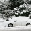 A man walks past a snow-covered car on a road in Buxton, Derbyshire, on 8 January 2025. Pic: Reuters