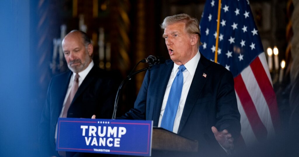 PALM BEACH, FLORIDA - DECEMBER 16: U.S. President-elect Donald Trump, accompanied by Trump's choice for Secretary of Commerce, Cantor Fitzgerald Chairman and CEO Howard Lutnick, speaks at a news conference at Trump's Mar-a-Lago resort on December 16, 2024 in Palm Beach, Florida. In a news conference that went over an hour, Trump announced that SoftBank will invest over $100 billion in projects in the United States including 100,000 artificial intelligence related jobs and then took questions on Syria, Israel, Ukraine, the economy, cabinet picks, and many other topics.   Andrew Harnik/Getty Images/AFP (Photo by Andrew Harnik / GETTY IMAGES NORTH AMERICA / Getty Images via AFP)