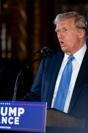 PALM BEACH, FLORIDA - DECEMBER 16: U.S. President-elect Donald Trump, accompanied by Trump's choice for Secretary of Commerce, Cantor Fitzgerald Chairman and CEO Howard Lutnick, speaks at a news conference at Trump's Mar-a-Lago resort on December 16, 2024 in Palm Beach, Florida. In a news conference that went over an hour, Trump announced that SoftBank will invest over $100 billion in projects in the United States including 100,000 artificial intelligence related jobs and then took questions on Syria, Israel, Ukraine, the economy, cabinet picks, and many other topics.   Andrew Harnik/Getty Images/AFP (Photo by Andrew Harnik / GETTY IMAGES NORTH AMERICA / Getty Images via AFP)