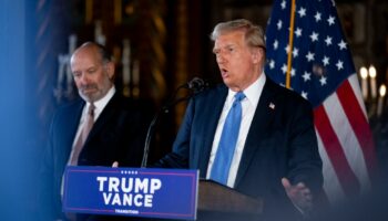 PALM BEACH, FLORIDA - DECEMBER 16: U.S. President-elect Donald Trump, accompanied by Trump's choice for Secretary of Commerce, Cantor Fitzgerald Chairman and CEO Howard Lutnick, speaks at a news conference at Trump's Mar-a-Lago resort on December 16, 2024 in Palm Beach, Florida. In a news conference that went over an hour, Trump announced that SoftBank will invest over $100 billion in projects in the United States including 100,000 artificial intelligence related jobs and then took questions on Syria, Israel, Ukraine, the economy, cabinet picks, and many other topics.   Andrew Harnik/Getty Images/AFP (Photo by Andrew Harnik / GETTY IMAGES NORTH AMERICA / Getty Images via AFP)