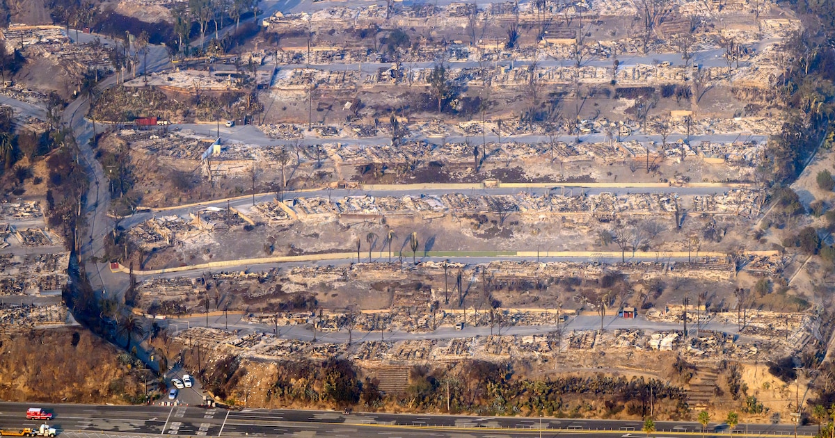 In this aerial view taken from a helicopter, burned homes are seen from above during the Palisades fire in Los Angeles county, California on January 9, 2025. Massive wildfires that engulfed whole neighborhoods and displaced thousands in Los Angeles remained totally uncontained January 9, 2025, authorities said, as US National Guard soldiers readied to hit the streets to help quell disorder. Swaths of the United States' second-largest city lay in ruins, with smoke blanketing the sky and an acrid smell pervading almost every building. (Photo by JOSH EDELSON / AFP)