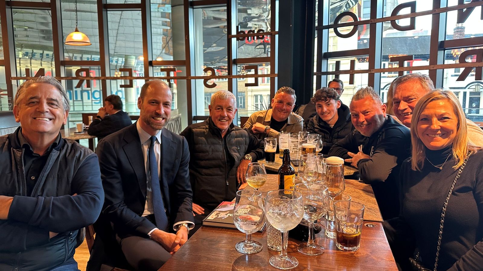 Prince William, second from left, with Aston Villa fans in Wetherspoons. Pic: PA