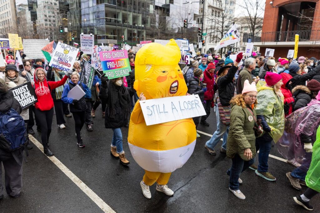 Trump inauguration moved inside by freezing weather as large crowds gather in Washington for protests: Live