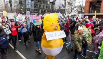 Trump inauguration moved inside by freezing weather as large crowds gather in Washington for protests: Live