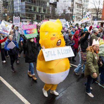 Trump inauguration moved inside by freezing weather as large crowds gather in Washington for protests: Live