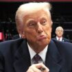 Donald Trump reacts as he signs an executive order during the inaugural parade inside Capital One Arena on the inauguration day of his second presidential term, in Washington, U.S. January 20, 2025. REUTERS/Carlos Barria