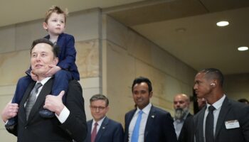 WASHINGTON, DC - DECEMBER 05: Tesla CEO Elon Musk, Co-Chair of the newly announced Department of Government Efficiency (DOGE) carries his son "X" on his shoulders at the U.S. Capitol after a media availability with businessman Vivek Ramaswamy (3rd R), Co-Chair of the newly announced Department of Government Efficiency and Speaker of the House Mike Johnson (4th R) (R-LA) on December 05, 2024 in Washington, DC. Musk and Ramaswamy are meeting with members of the U.S. Congress today about DOGE, a planned presidential advisory commission with the goal of cutting government spending and increasing efficiency in the federal workforce.   Andrew Harnik/Getty Images/AFP (Photo by Andrew Harnik / GETTY IMAGES NORTH AMERICA / Getty Images via AFP)