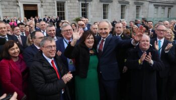 Fianna Fail leader Micheal Martin (centre) with his wife Mary outside Leinster House, Dublin, after he was selected as the new Taoiseach. Pic: PA