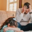 Shot of a father and daughter looking frustrated while completing homework together at home