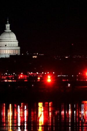 Emergency personnel work near the site of the crash, with the U.S. Capitol in the background, after American Eagle flight 5342 collided with a Black Hawk helicopter while approaching Ronald Reagan Washington National Airport and crashed in the Potomac River, U.S. January 30, 2025. REUTERS/Nathan Howard TPX IMAGES OF THE DAY