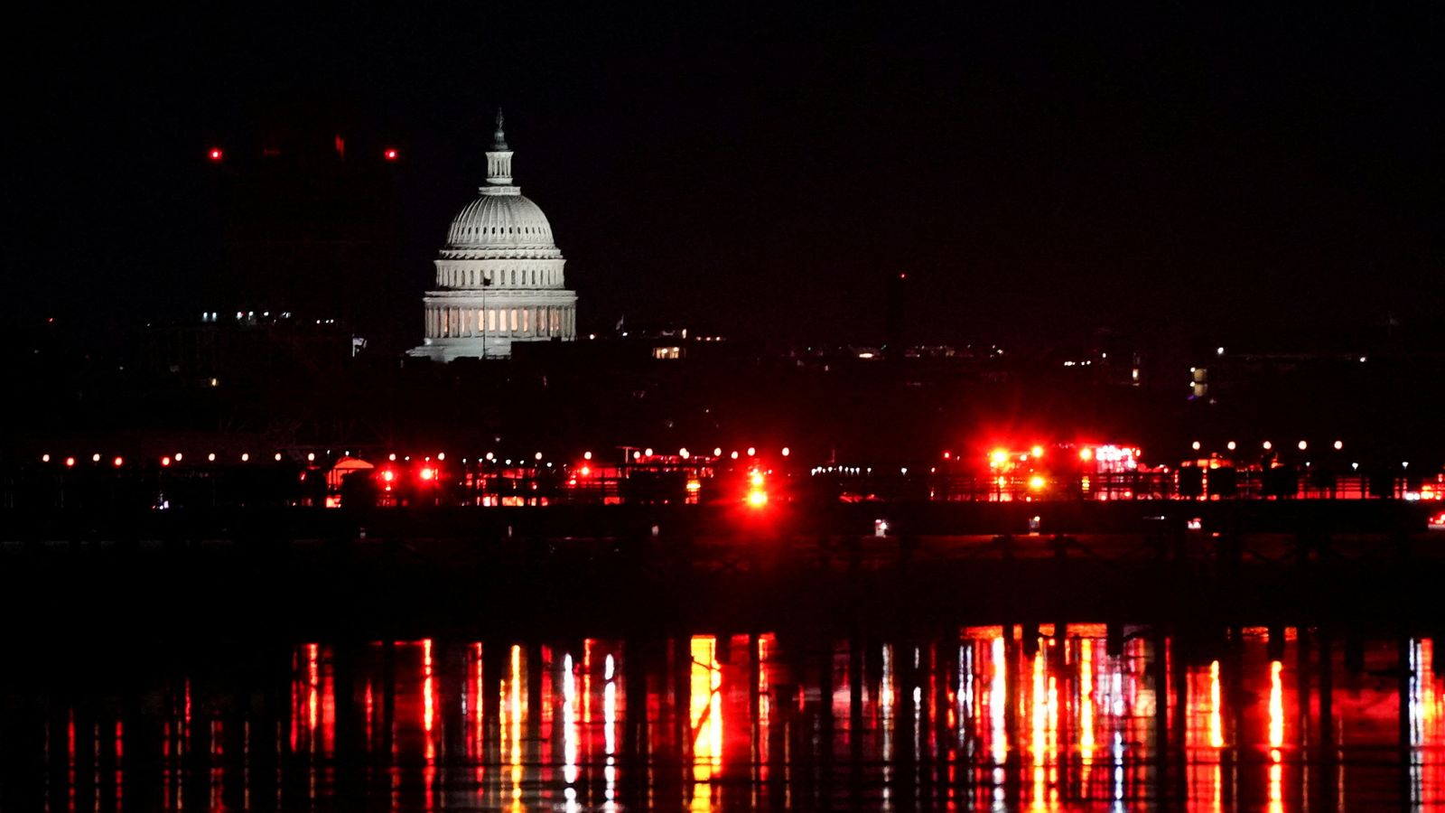 Emergency personnel work near the site of the crash, with the U.S. Capitol in the background, after American Eagle flight 5342 collided with a Black Hawk helicopter while approaching Ronald Reagan Washington National Airport and crashed in the Potomac River, U.S. January 30, 2025. REUTERS/Nathan Howard TPX IMAGES OF THE DAY