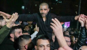 Zaharia Zubeidi , former leader of the Al-Aqsa Martyrs Brigade, an armed offshoot of the secular Fatah party, is greeted upon his arrival after being released from an Israeli prison in the West Bank city of Ramallah, Thursday Jan. 30, 2025.(AP Photo/Nasser Nasser)