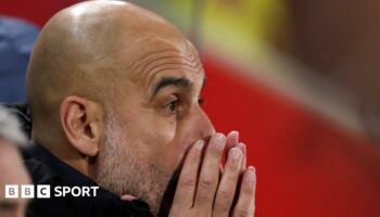 Pep Guardiola with his hands partially covering his face