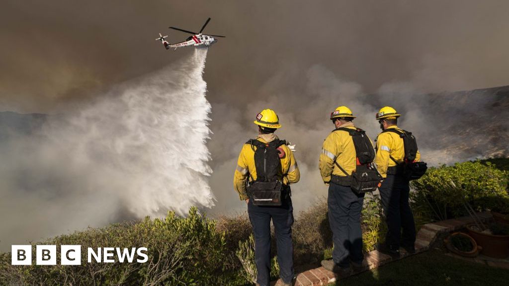 As winds pick up, LA firefighters desperately battle to contain monster inferno